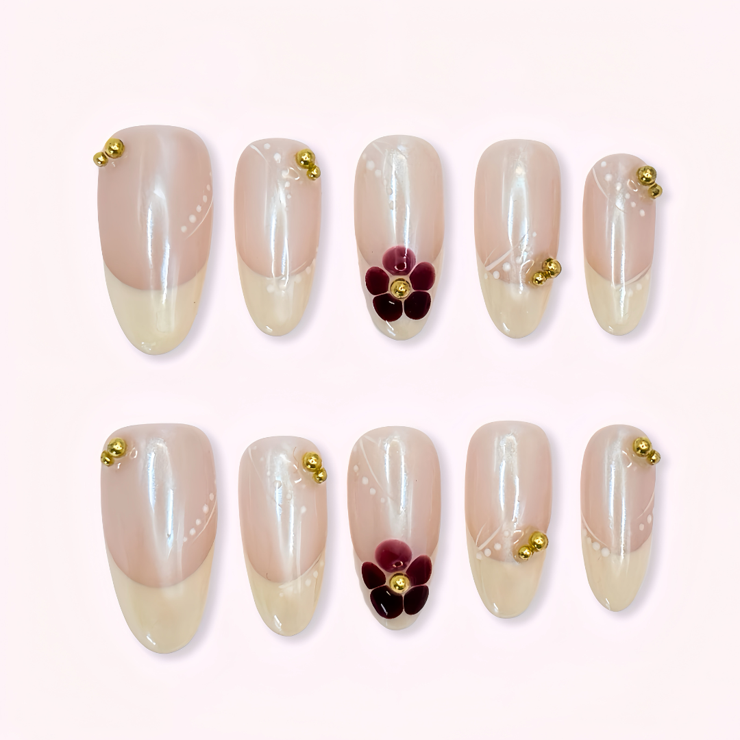 Set of nail art designs with flowers and gold accents on a butter yellow french