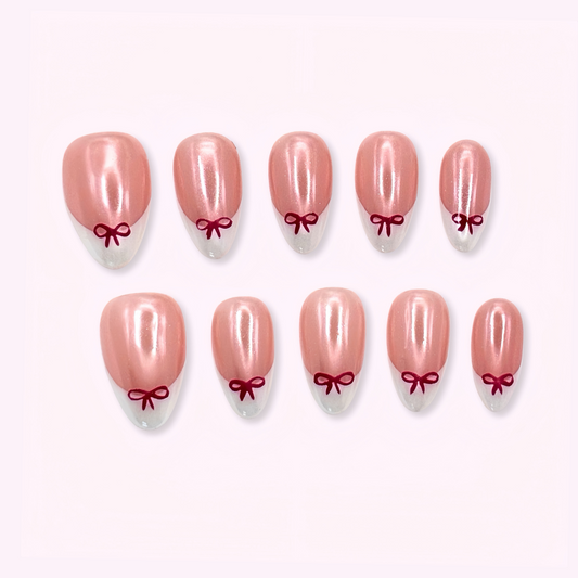 Pinkie Promise Nails Press-Ons Reusable Best Press-on Nails Salon Quality Nails at home Daphne Short Almond Squoval Press-On Nails, Set of pink nail extensions with red bow designs 