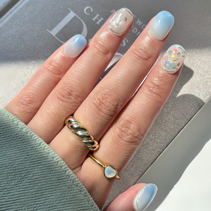 Pinkie Promise Nails Press-Ons Reusable Best Press-on Nails Salon Quality Nails at home Sky Extra Short Round Hand Image Build Your Kit Press-On Nails, Hand with light blue nail polish and gold rings 